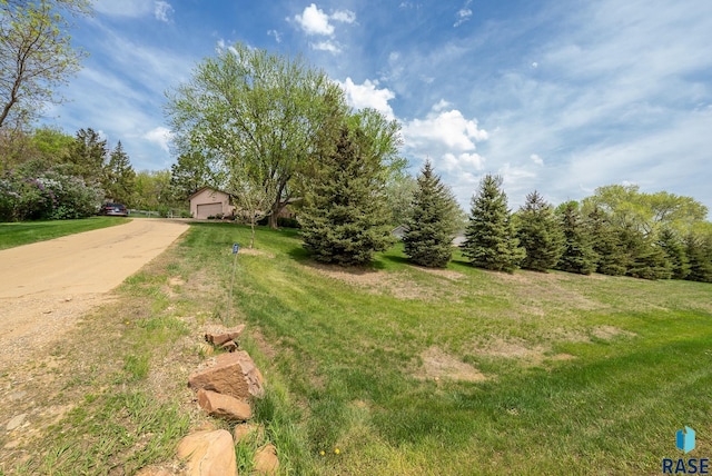 view of grassy yard with a garage
