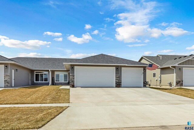 5307 S Dubuque Ave, Sioux Falls, SD 57108 - ranch-style home with an attached garage, concrete driveway, a front lawn, and roof with shingles
