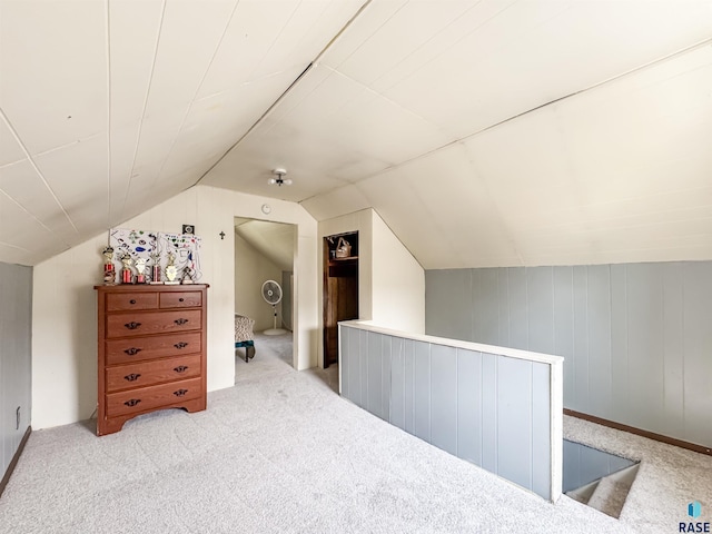 bonus room with carpet floors and vaulted ceiling