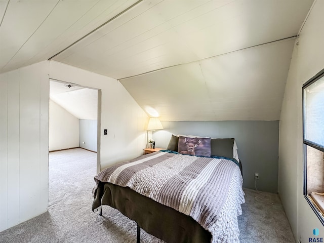 carpeted bedroom with lofted ceiling