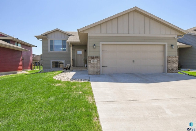 9425 W Liam St, Sioux Falls, SD 57106 - view of front of property with brick siding, an attached garage, a front yard, driveway, and board and batten siding