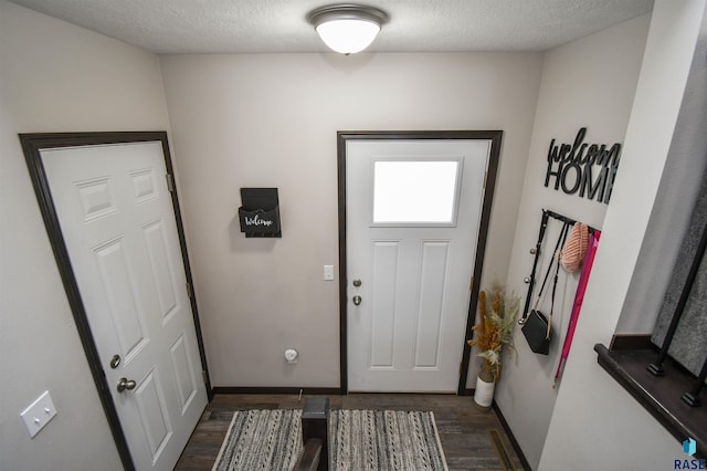 9425 W Liam St, Sioux Falls, SD 57106 - doorway to outside with dark wood finished floors, baseboards, and a textured ceiling