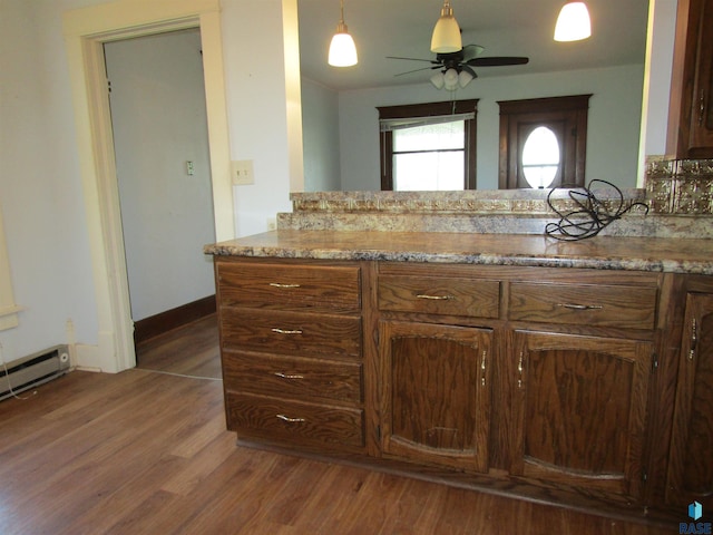 bathroom with wood finished floors, a ceiling fan, baseboards, and vanity