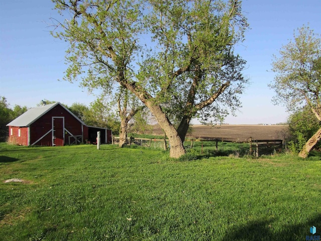 view of green lawn with a barn and an outdoor structure