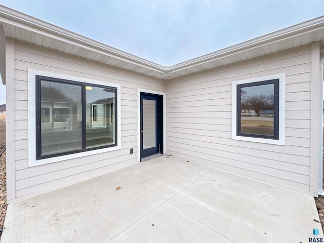property entrance featuring a patio area