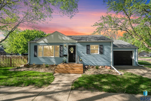 view of front of property with a garage, roof with shingles, and driveway