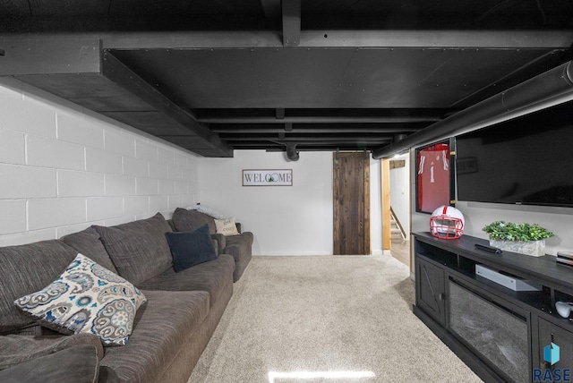 carpeted living room featuring concrete block wall and stairs