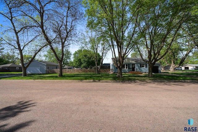 ranch-style house with fence and a detached garage