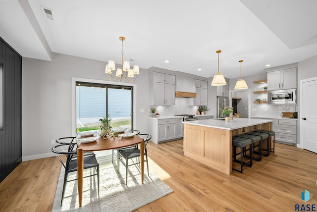 6609 E Corsair Dr, Sioux Falls, SD 57110 - kitchen featuring stainless steel appliances, custom exhaust hood, open shelves, light countertops, and recessed lighting