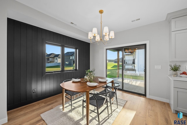 6609 E Corsair Dr, Sioux Falls, SD 57110 - dining room featuring light wood-style flooring, plenty of natural light, a chandelier, and baseboards