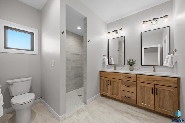 6609 E Corsair Dr, Sioux Falls, SD 57110 - bathroom featuring baseboards, a walk in shower, toilet, and double vanity