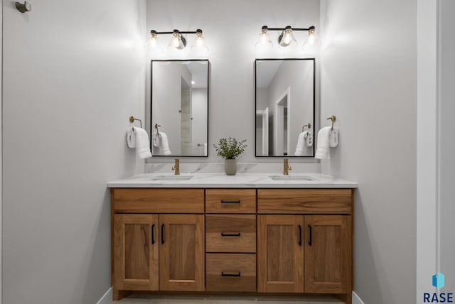 6609 E Corsair Dr, Sioux Falls, SD 57110 - bathroom featuring double vanity and baseboards