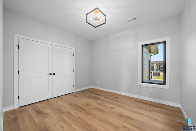 6609 E Corsair Dr, Sioux Falls, SD 57110 - unfurnished bedroom with light wood-type flooring, baseboards, and a closet