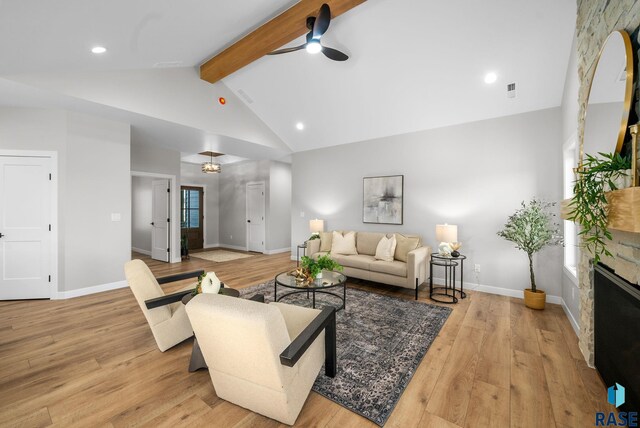 6609 E Corsair Dr, Sioux Falls, SD 57110 - living area with ceiling fan, beamed ceiling, light wood-type flooring, a fireplace, and high vaulted ceiling