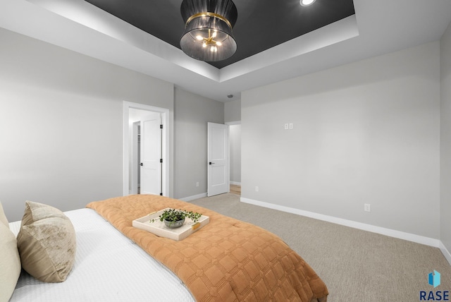 6609 E Corsair Dr, Sioux Falls, SD 57110 - bedroom with baseboards, light colored carpet, and a raised ceiling