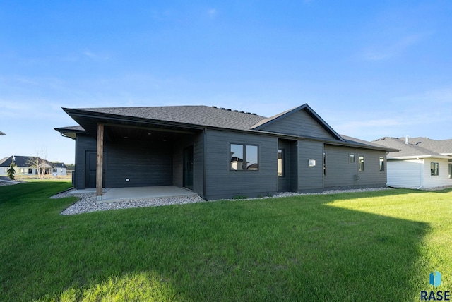 6609 E Corsair Dr, Sioux Falls, SD 57110 - rear view of property with a patio area, a lawn, and a shingled roof