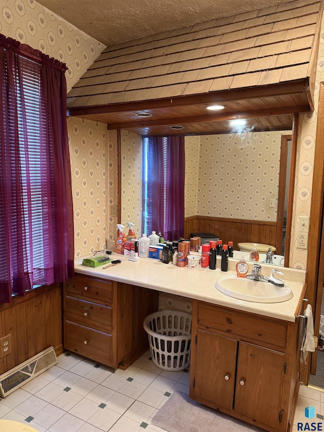 bathroom featuring wallpapered walls, vanity, a wainscoted wall, tile patterned flooring, and wood walls