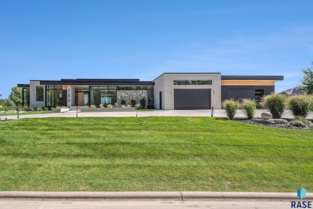 modern home featuring a front yard and an attached garage