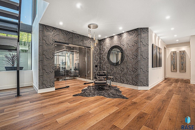 exercise area with wood-type flooring, baseboards, and recessed lighting