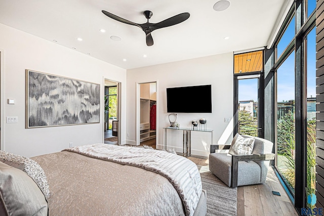 bedroom featuring hardwood / wood-style floors, recessed lighting, ceiling fan, and baseboards