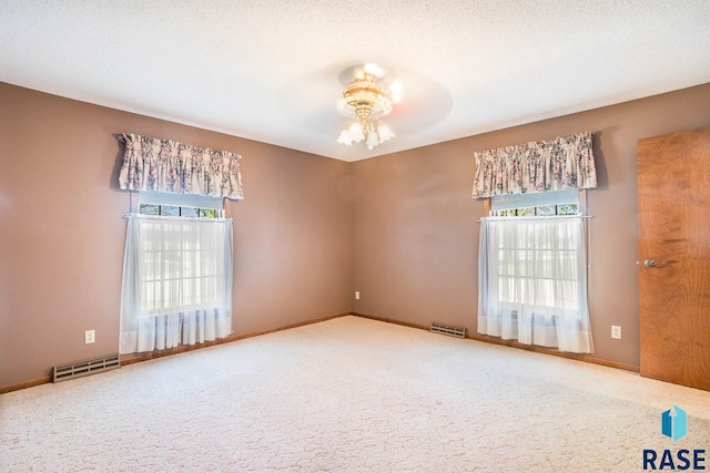 1208 Hampshire Cir, Luverne, MN 56156 - carpeted empty room featuring healthy amount of natural light, a ceiling fan, and baseboards
