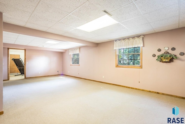1208 Hampshire Cir, Luverne, MN 56156 - basement with baseboards, carpet floors, and a paneled ceiling