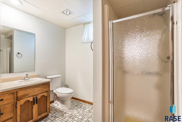1208 Hampshire Cir, Luverne, MN 56156 - full bathroom featuring a stall shower, toilet, vanity, a drop ceiling, and baseboards