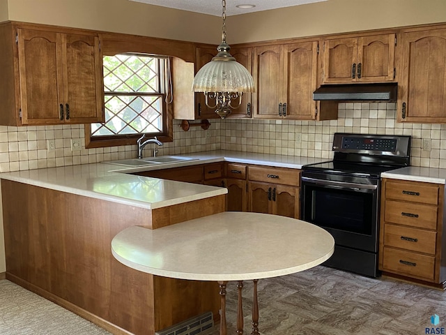 1208 Hampshire Cir, Luverne, MN 56156 - kitchen with electric range oven, a sink, under cabinet range hood, a peninsula, and brown cabinets