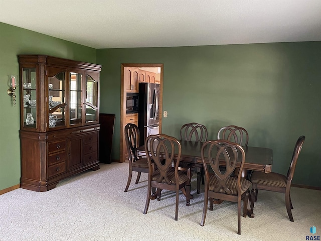1208 Hampshire Cir, Luverne, MN 56156 - dining area featuring light colored carpet and baseboards