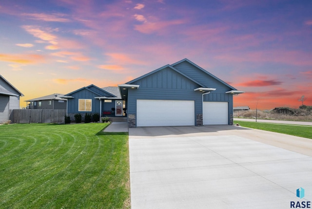 4205 W 77th St, Sioux Falls, SD 57108 - view of front facade with board and batten siding, a garage, driveway, and stone siding