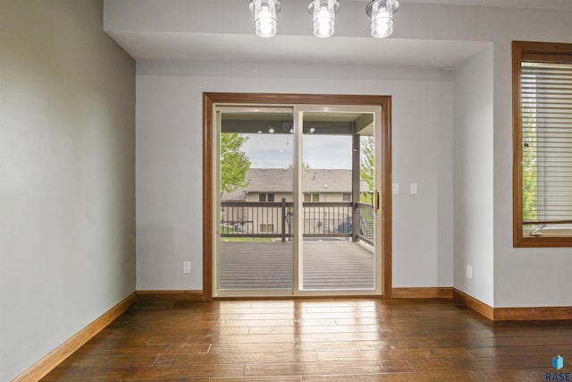 doorway to outside featuring wood-type flooring and baseboards