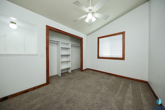 unfurnished bedroom with carpet floors, a closet, baseboards, and lofted ceiling