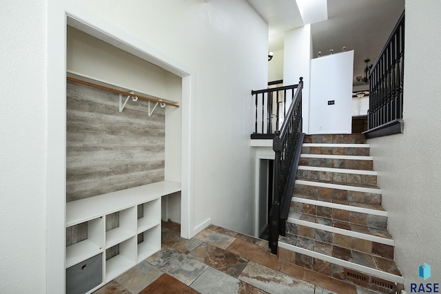 stairway with stone tile flooring