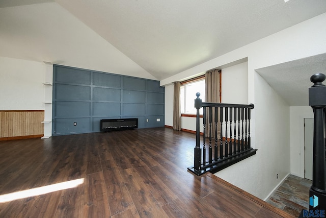 unfurnished living room featuring wood finished floors, lofted ceiling, radiator heating unit, and baseboards