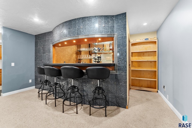 indoor wet bar with carpet, recessed lighting, and baseboards