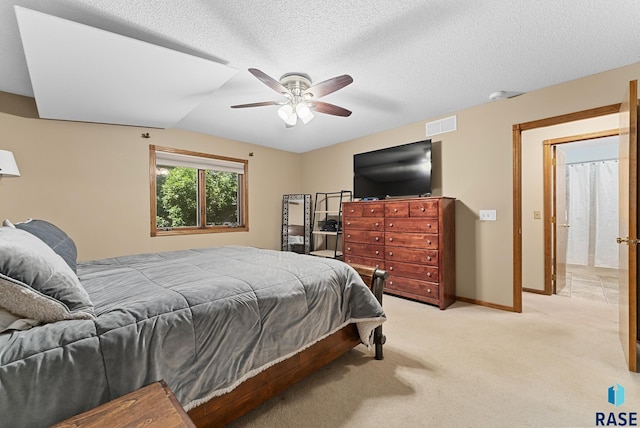 bedroom with light colored carpet, a ceiling fan, lofted ceiling, a textured ceiling, and baseboards