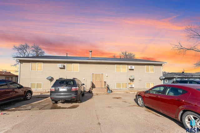 301 W Prospect Ave, Flandreau, SD 57028 - view of front of house featuring entry steps, a wall mounted AC, and uncovered parking