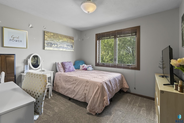 carpeted bedroom featuring baseboards