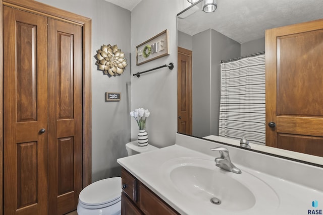 full bathroom with toilet, vanity, and curtained shower