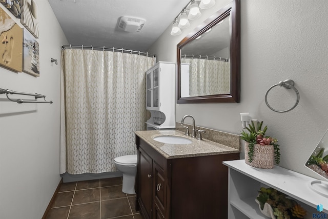 bathroom with vanity, tile patterned flooring, toilet, and curtained shower