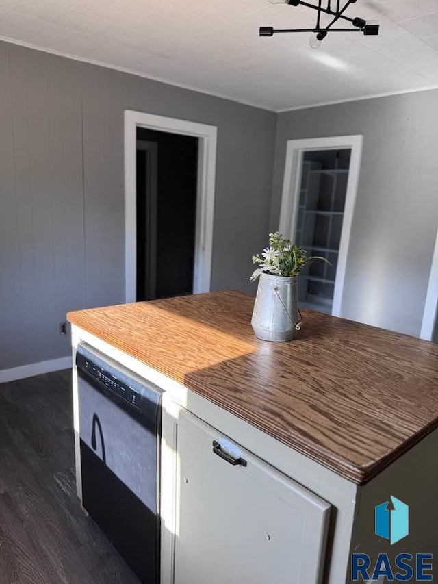kitchen featuring dark wood-style flooring, baseboards, white cabinetry, dishwasher, and a chandelier