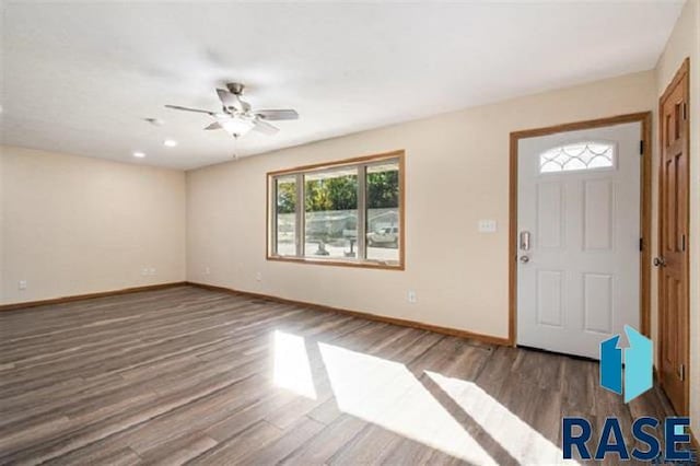 foyer featuring wood finished floors, baseboards, and ceiling fan