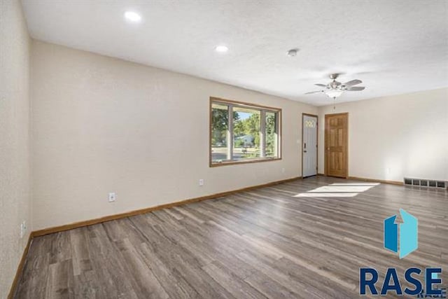 empty room with baseboards, wood finished floors, ceiling fan, and recessed lighting