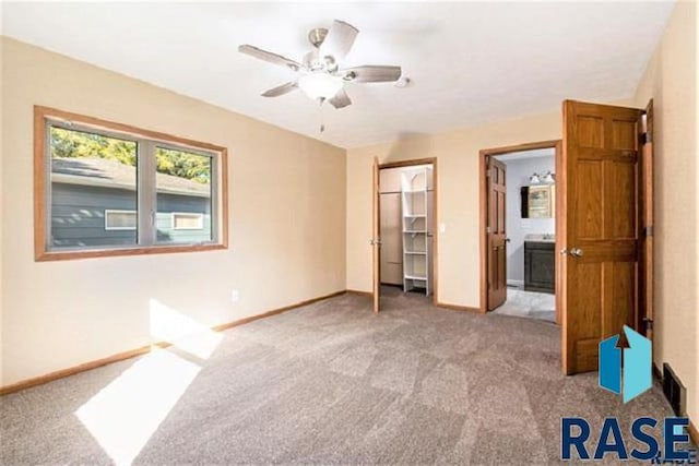 unfurnished bedroom featuring carpet, baseboards, ceiling fan, and a closet
