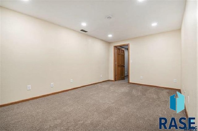 spare room featuring carpet flooring, recessed lighting, and baseboards