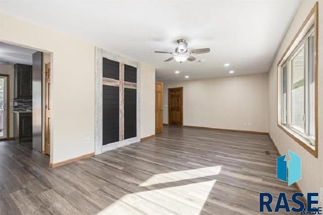 empty room featuring wood finished floors, baseboards, a ceiling fan, and recessed lighting