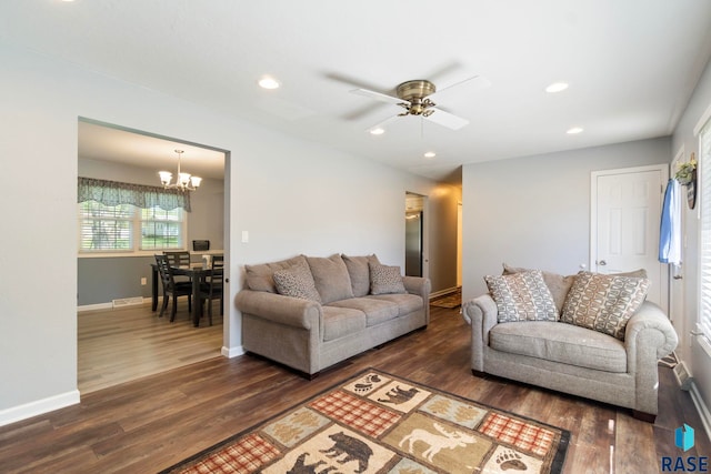 living area with a chandelier, dark wood finished floors, ceiling fan, recessed lighting, and baseboards