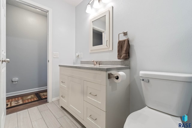 half bathroom featuring toilet and vanity