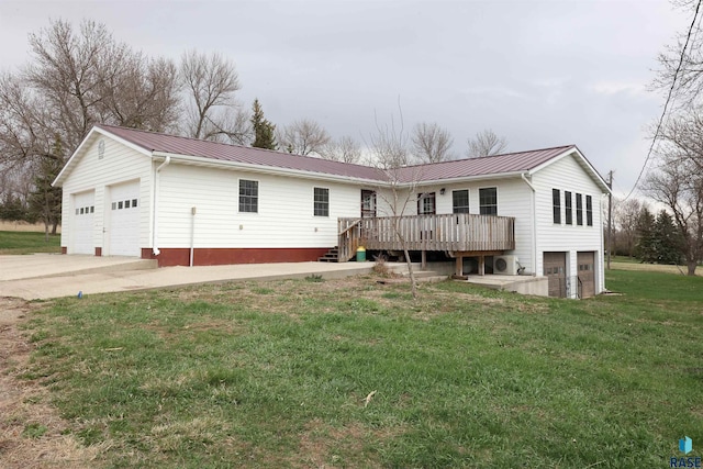 47743 233a St, Egan, SD 57024 - view of front facade featuring a garage, a front yard, metal roof, and a deck