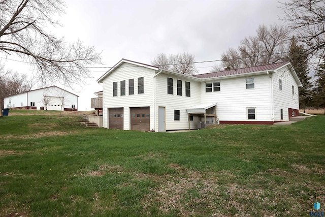 47743 233a St, Egan, SD 57024 - back of property featuring metal roof, a yard, a garage, and a standing seam roof